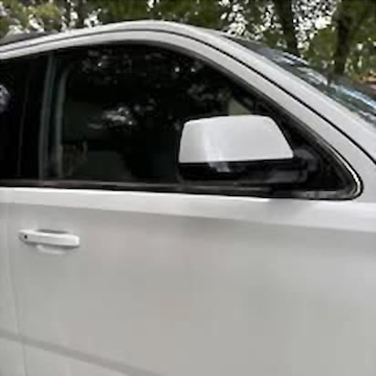 Glossy white SUV side and mirror after detailing